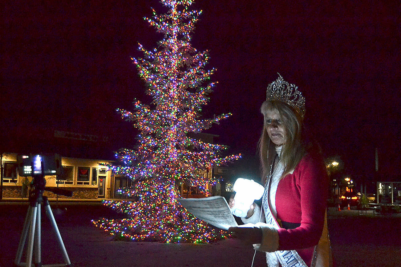 Captain-Crystal Stout sings "It’s beginning to look a lot like Christmas (in Sequim)” to celebrate the lighting of the Sequim tree on Thanksgiving night. Matthew Nash/Olympic Peninsula News Group