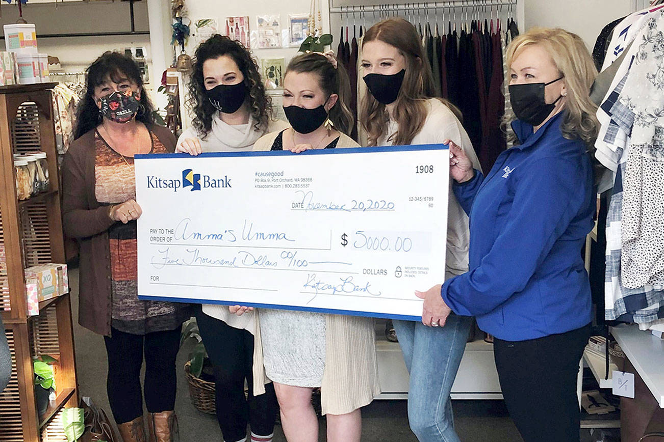 Kitsap Bank employees Julie Hatch, on left, and Tammy Armacost, on right, present the Community edg3 award to Amma’s Umma staff, in the center, from left to right, Chelsea Lierly, Chelsea Winfield and Alisha Grasser.