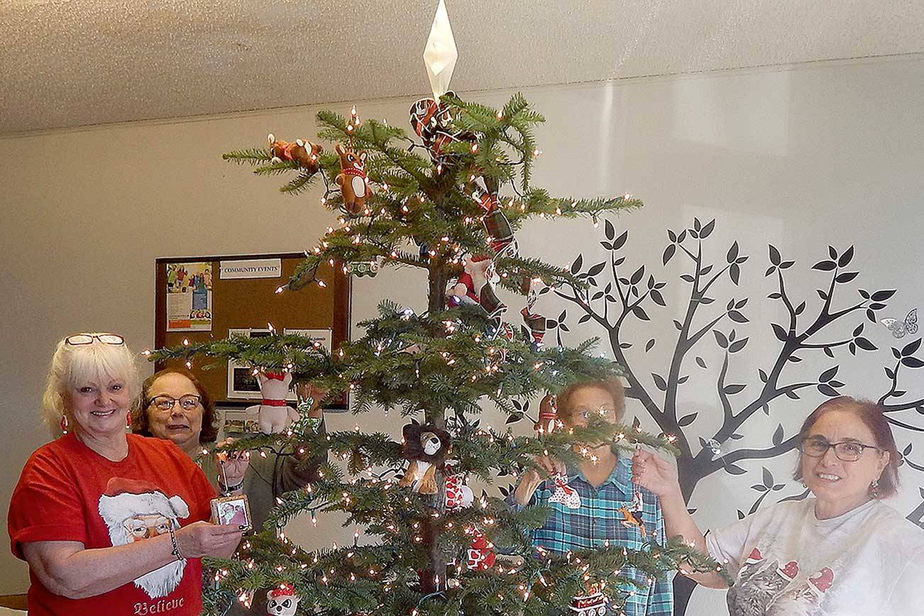 Pam Nelson, Punky Goakey, Janet Marion and Sharla Fraker decorate . This group of ladies has been participating in the Festival of Trees for years and start planning their next tree as soon as the auction is over.