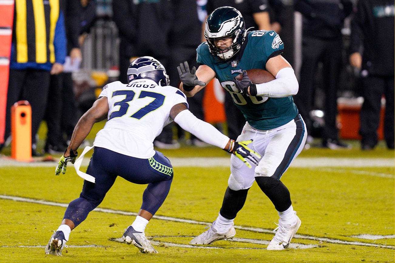 Philadelphia Eagles' Dallas Goedert (88) tries to get past Seattle Seahawks' Quandre Diggs (37) during the second half of an NFL football game, Monday, Nov. 30, 2020, in Philadelphia. (AP Photo/Chris Szagola)