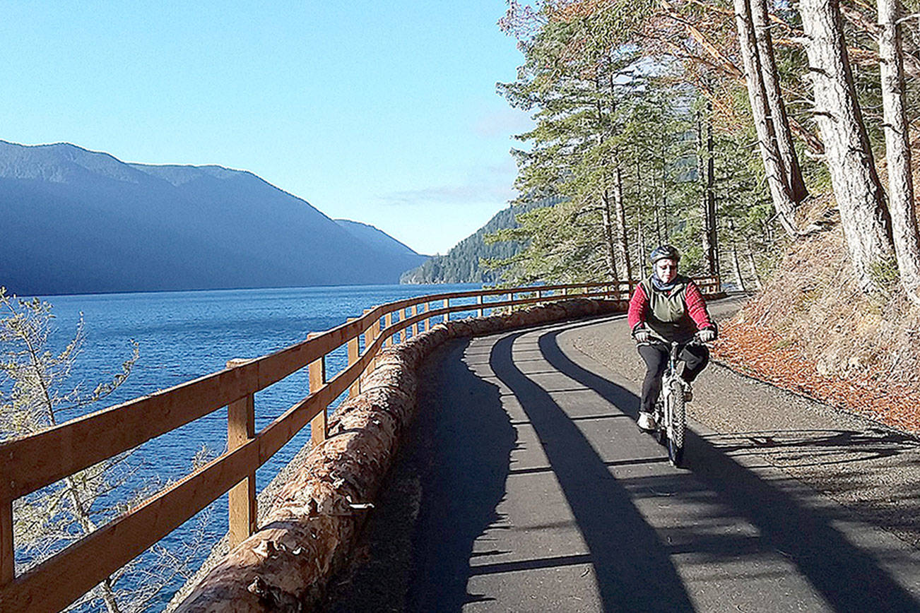 Pierre LaBossiere/Peninsula Daily News
Bicyclists and hikers enjoy beautiful weather at the new Spruce Railroad Trail on Wednesday on the north shore of Crescent Lake. Here a cyclist rides the trail just west of the Daley Rankin Tunnel.