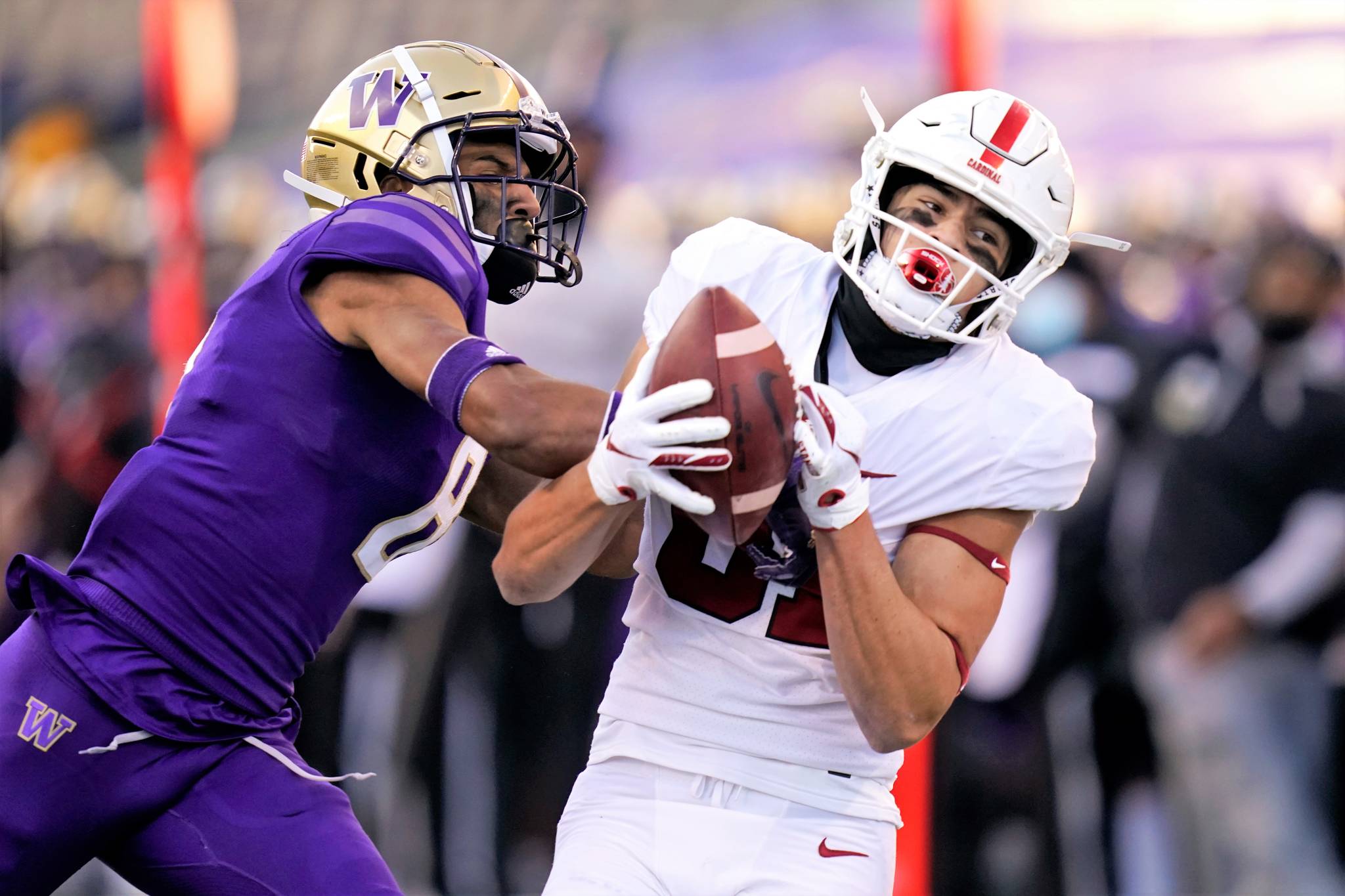 Stanford wide receiver Brycen Tremayne, right, catches a 33-yard pass as Washington defensive back Keith Taylor defends Saturday in Seattle. (AP Photo/Elaine Thompson)