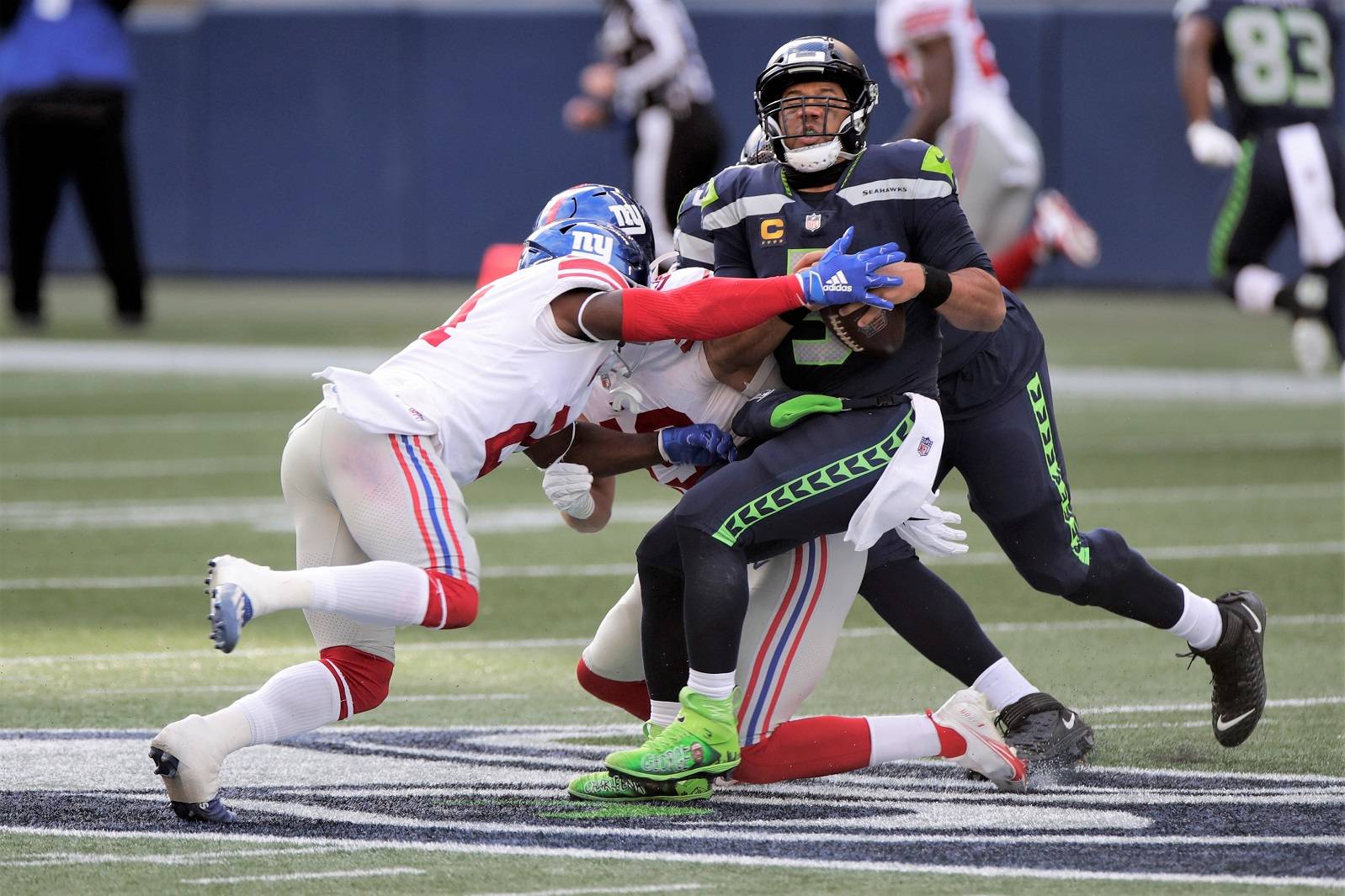 Seattle Seahawks quarterback Russell Wilson is sacked by New York Giants safety Jabrill Peppers, left, during the first half of an NFL football game, Sunday, Dec. 6, 2020, in Seattle. (AP Photo/Larry Maurer)