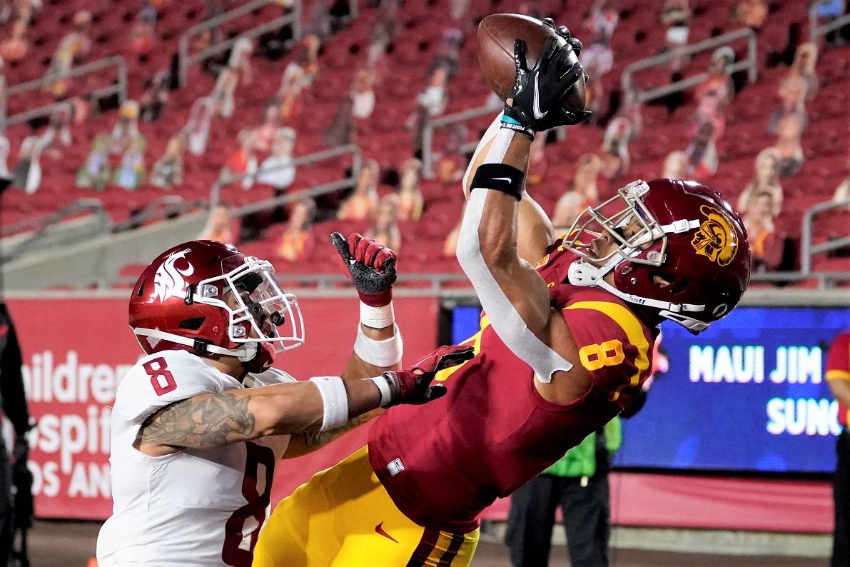 Southern California wide receiver Amon-Ra St. Brown, right, catches a touchdown over Washington State defensive back Armani Marsh during the first half of an NCAA college football game in Los Angeles, Sunday, Dec. 6, 2020. (AP Photo/Alex Gallardo)