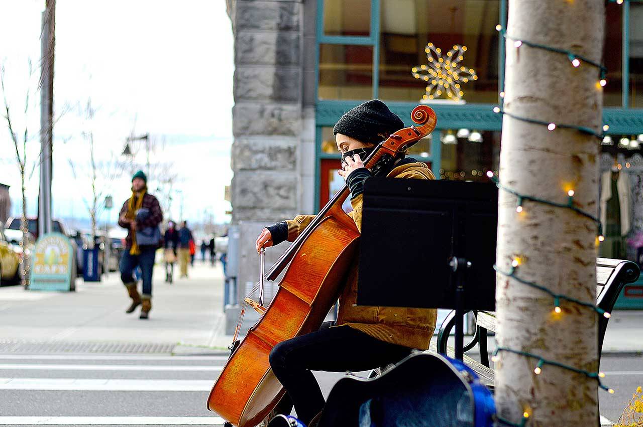 Downtown music making, such as that by cellist Sage Coy, has long been part of Port Townsend’s cultural identity. Now, with the state officially naming a Creative District within the city, artists are invited to submit proposals for wayfinding art markers downtown, Uptown and at Fort Worden State Park. (Diane Urbani de la Paz/Peninsula Daily News)