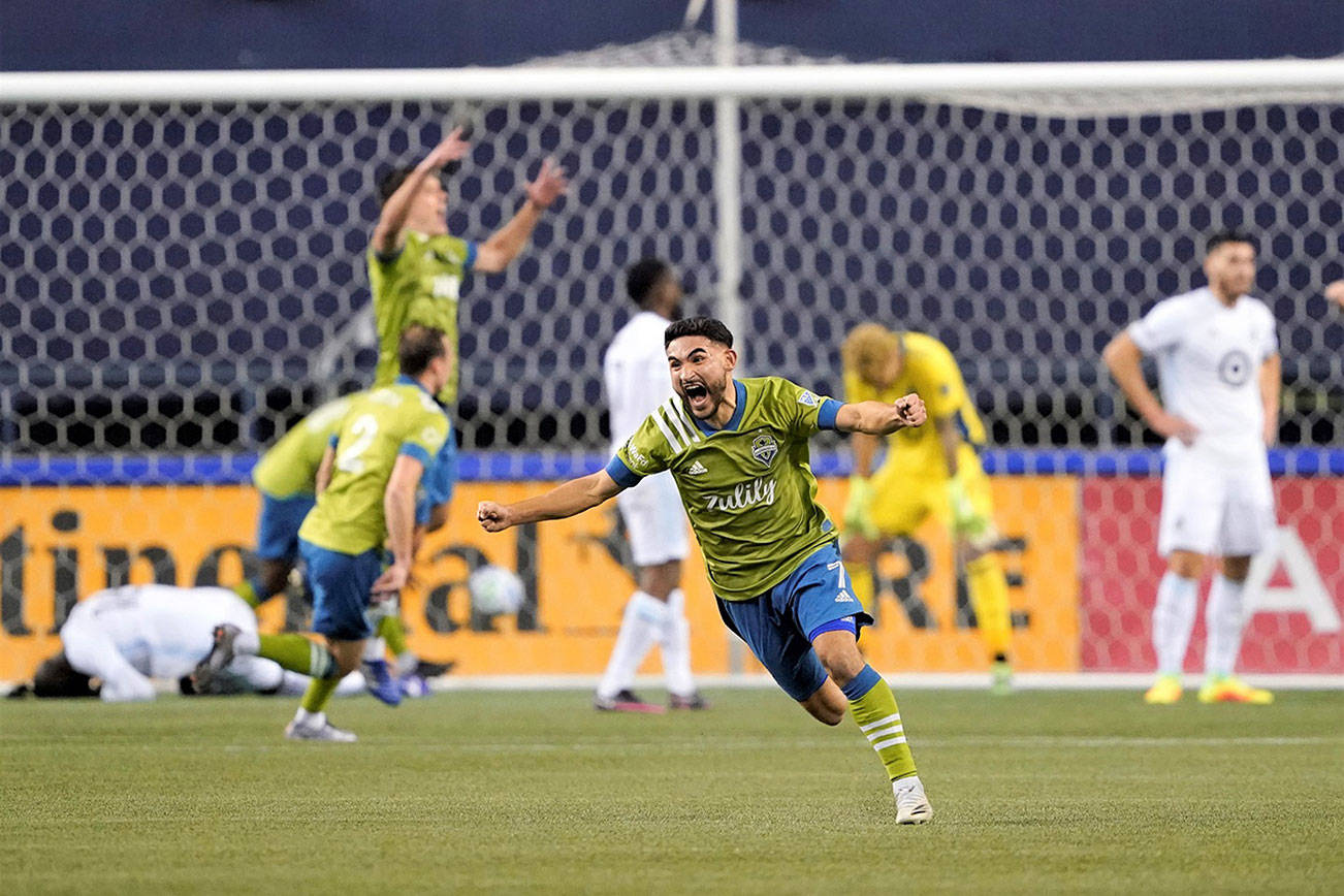 Seattle Sounders' Cristian Roldan (7) celebrates a Sounders goal late in the second half of an MLS playoff Western Conference final soccer match against Minnesota United, Monday, Dec. 7, 2020, in Seattle. The Sounders won 3-2. (AP Photo/Ted S. Warren)