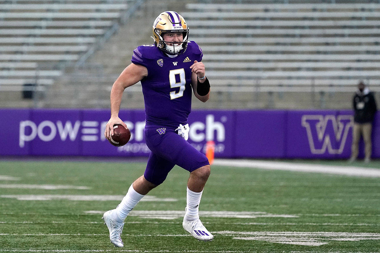 Washington quarterback Dylan Morris carries the ball against Stanford in the second half of an NCAA college football game Saturday, Dec. 5, 2020, in Seattle. (AP Photo/Elaine Thompson)