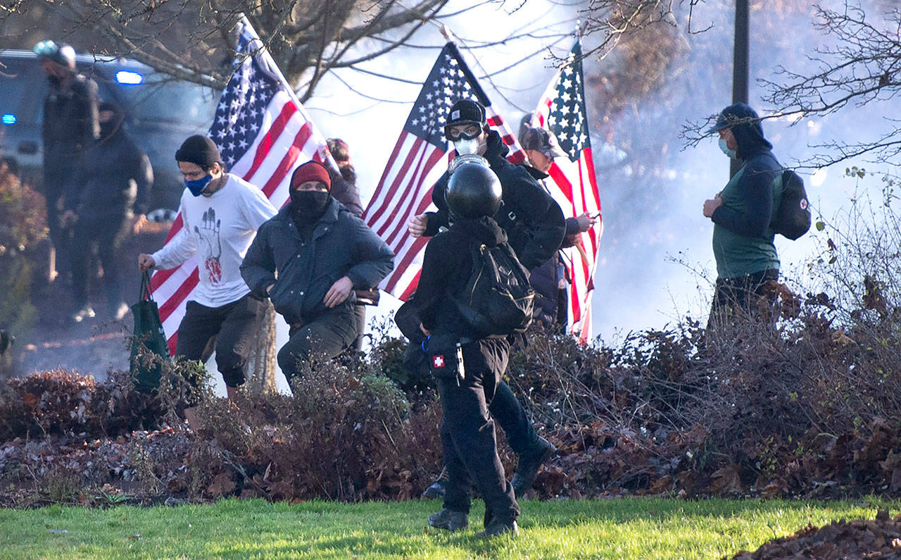 Supporters of President Donald Trump and antifa supporters clashed with Washington state police on the state Capitol Campus in Olympia on Saturday. Police in Olympia declared a riot early Saturday afternoon and arrested at least one person as groups with different points of view held simultaneous protests. (The Olympian via AP)