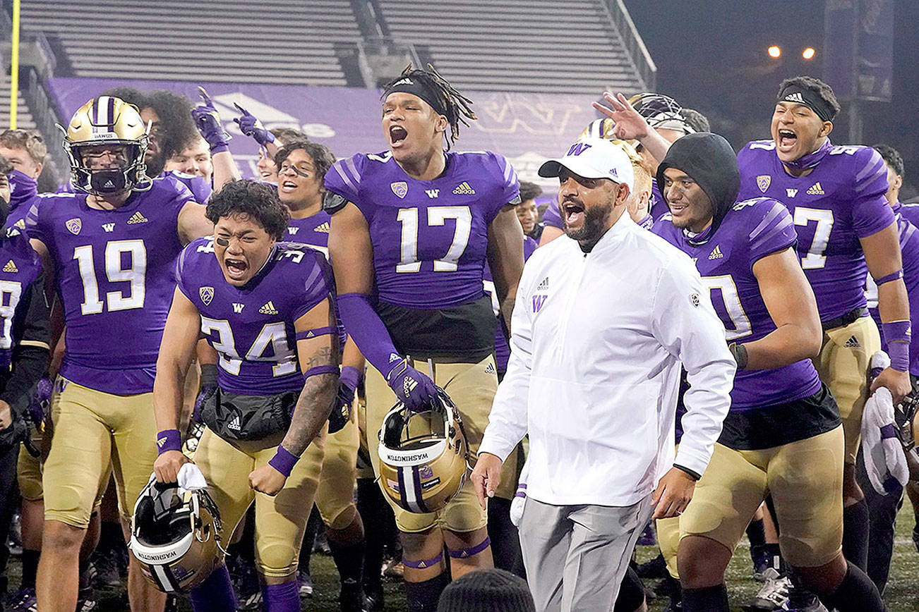 Washington coach Jimmy Lake celebrates with the team after Washington defeated Utah 24-21 in an NCAA college football game Saturday, Nov. 28, 2020, in Seattle. (AP Photo/Ted S. Warren)