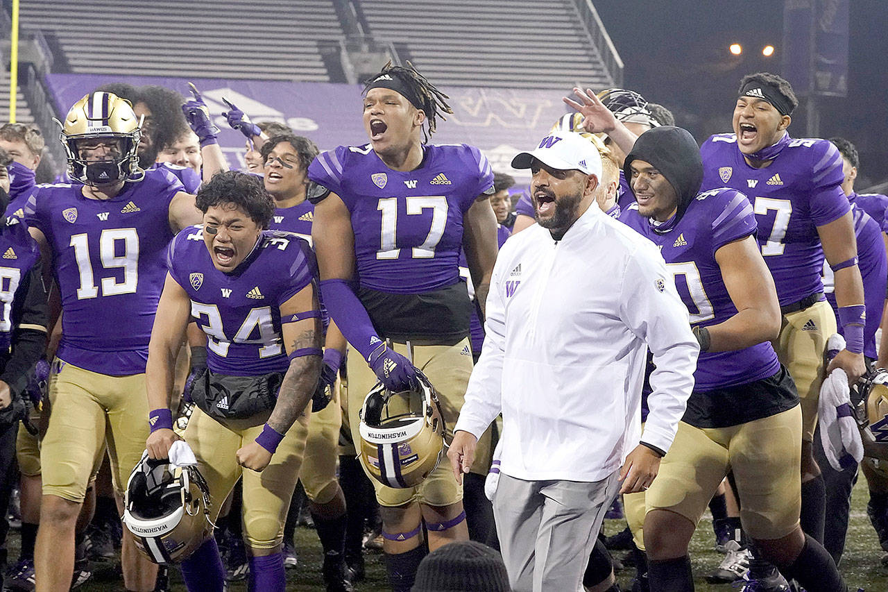 Washington coach Jimmy Lake celebrates with the team after Washington defeated Utah 24-21 in an NCAA college football game Saturday, Nov. 28, 2020, in Seattle. (Ted S. Warren/Associated Press)