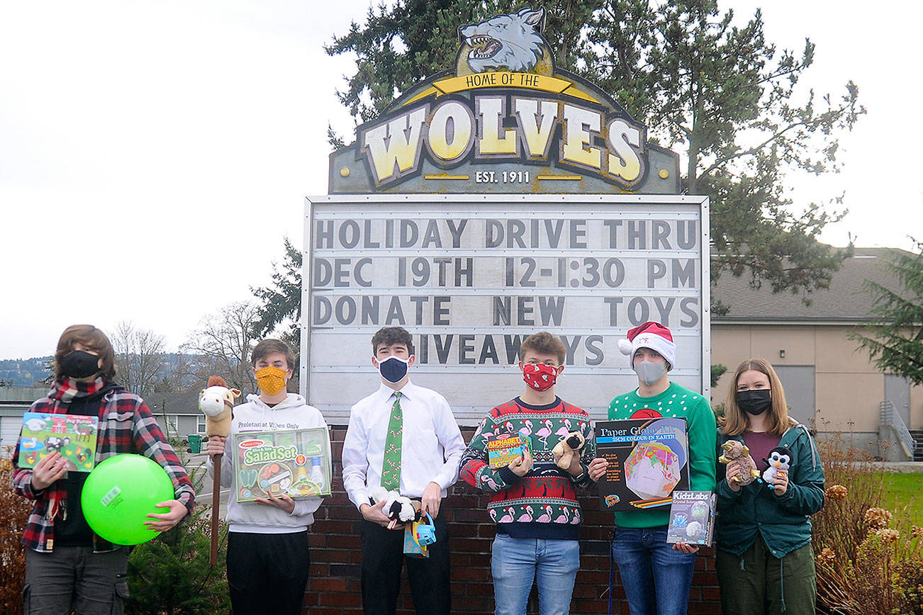 From left, Sequim High leadership students Richard Meier, Erik Holtrop, Dustan Koch, Aidan Braaten, Kaleb Needoba and Hannah Hampton make plans for a special holiday-themed drive-thru and toy drive, slated for noon to 1:30 p.m. Saturday at the high school. Michael Dashiell/Olympic Peninsula News Group