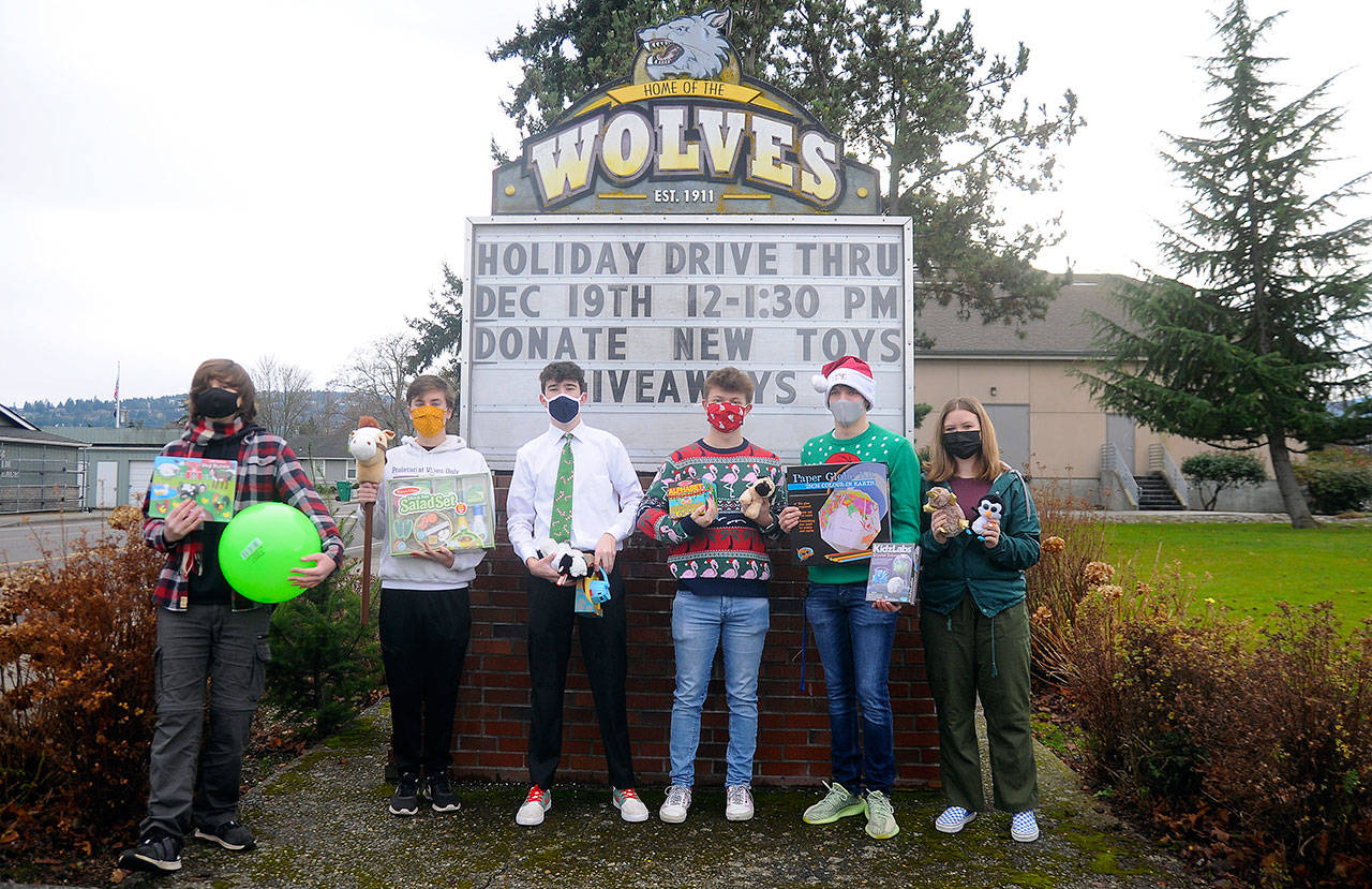 From left, Sequim High leadership students Richard Meier, Erik Holtrop, Dustan Koch, Aidan Braaten, Kaleb Needoba and Hannah Hampton make plans for a special holiday-themed drive-thru and toy drive, slated for noon to 1:30 p.m. Saturday, Dec. 19, 2020, at the high school. (Michael Dashiell/Olympic Peninsula News Group)