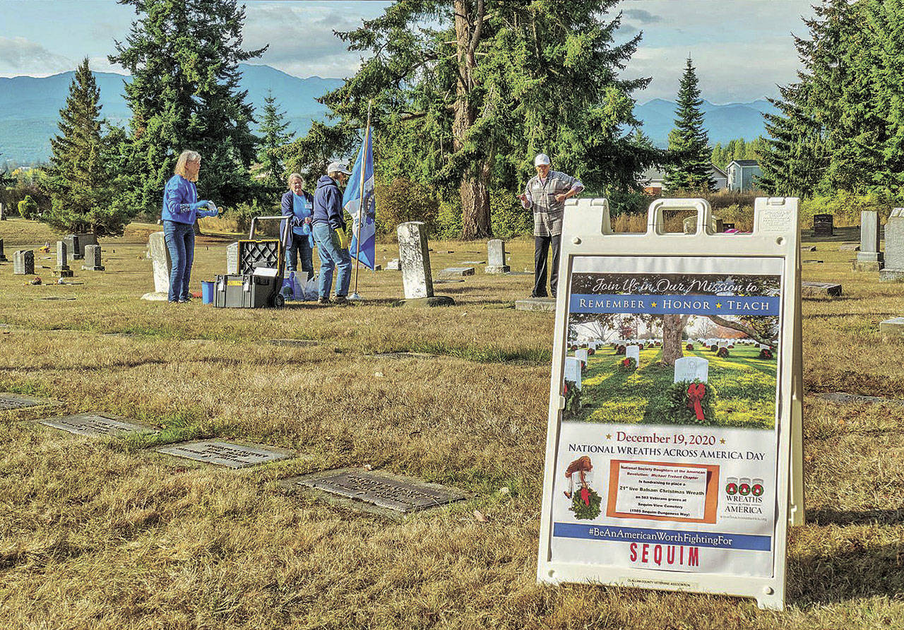 Members of the Michael Trebert Chapter of the Daughters of the American Revolution and Sequim Sunrise Rotary members clean graves at the Sequim View Cemetery in September. The cemetery hosts a Wreaths Across America event Sept. 19. (Photo courtesy of Bob Lampert)