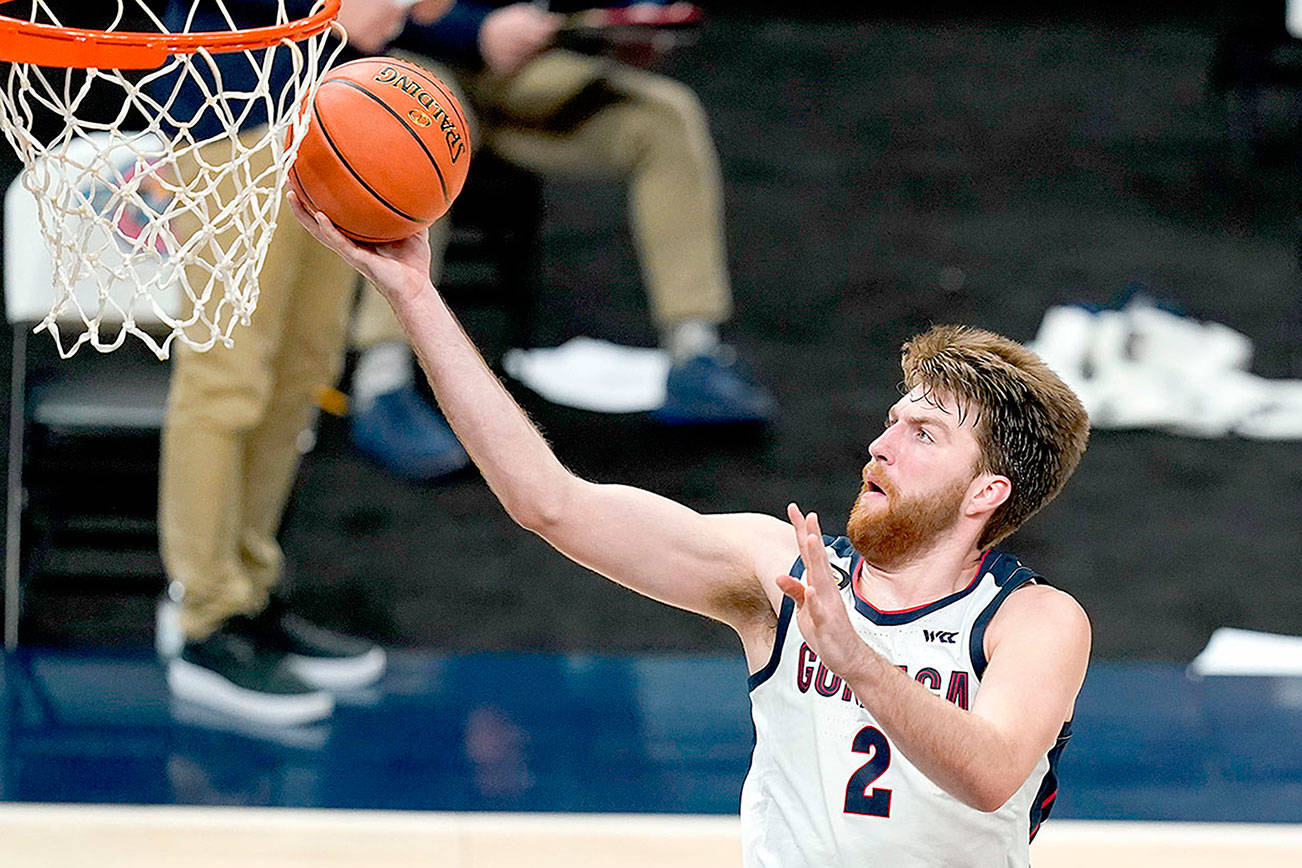 FILE - In this Dec. 2, 2020, file photo, Gonzaga's Drew Timme goes to the basket during the second half of the team's NCAA college basketball game against West Virginia in Indianapolis. Coach Mark Few of top-ranked Gonzaga says the suspension of basketball activities for the past two weeks because of the coronavirus pandemic has ''not helped us in any way, shape or form.″ (AP Photo/Darron Cummings, File)