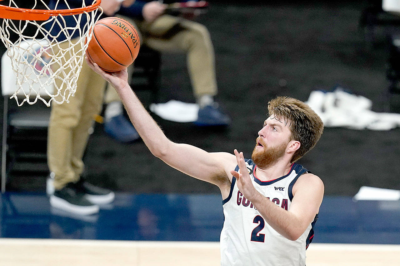 In this Dec. 2, 2020, file photo, Gonzaga’s Drew Timme goes to the basket during the second half of the team’s NCAA college basketball game against West Virginia in Indianapolis. Coach Mark Few of top-ranked Gonzaga says the suspension of basketball activities for the past two weeks because of the coronavirus pandemic has “not helped us in any way, shape or form.” (Darron Cummings/Associated Press file)