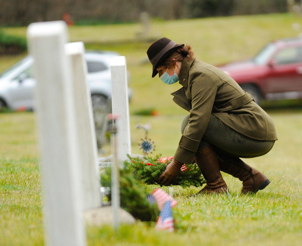 Lance Cpl. Holly Rowan, a U.S. Marine Corps veteran, lays a ceremonial wreath at Saturday’s Wreaths Across America event at Sequim View Cemetery. (Michael Dashiell/Olympic Peninsula News Group)