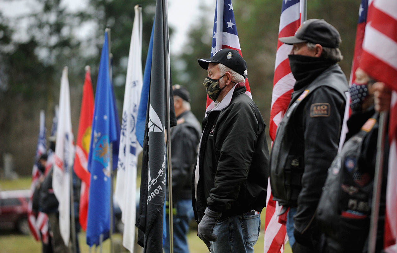 Members of the Clallam County Legion Riders Post 29 create a flag line as a patriotic backdrop to the Wreaths Across America event held Dec. 19 at Sequim View Cemetery. (Michael Dashiell/Olympic Peninsula News Group)