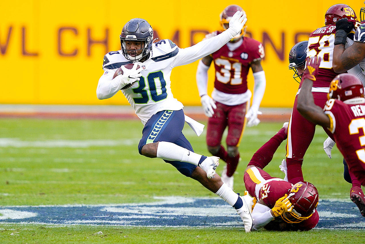 Seattle Seahawks running back Carlos Hyde (30) breaks away from Washington cornerback Ronald Darby (23) to begin his 50-yard touchdown run Sunday in Landover, Md. (Susan Walsh/The Associated Press)