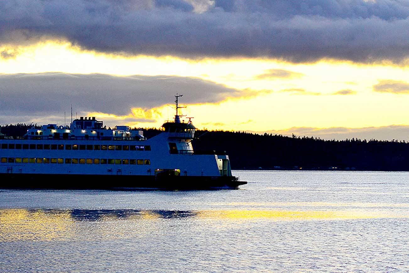 A hint of sunlight shines on a Washington State Ferry on Tuesday, the day after the winter solstice, as it sails into Port Townsend. The sun will rise a few more minutes earlier each day and set a few minutes later through the spring equinox on March 20. (Diane Urbani de la Paz/Peninsula Daily News)