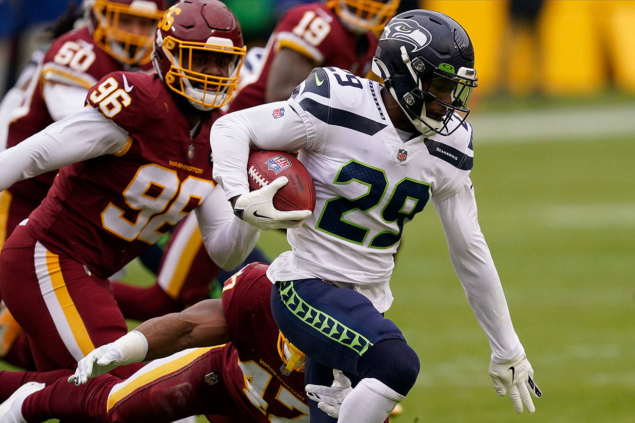 Seattle Seahawks free safety D.J. Reed (29) runs with the ball during the first half of an NFL football game against the Washington Football Team, Sunday, Dec. 20, 2020, in Landover, Md. (AP Photo/Andrew Harnik)