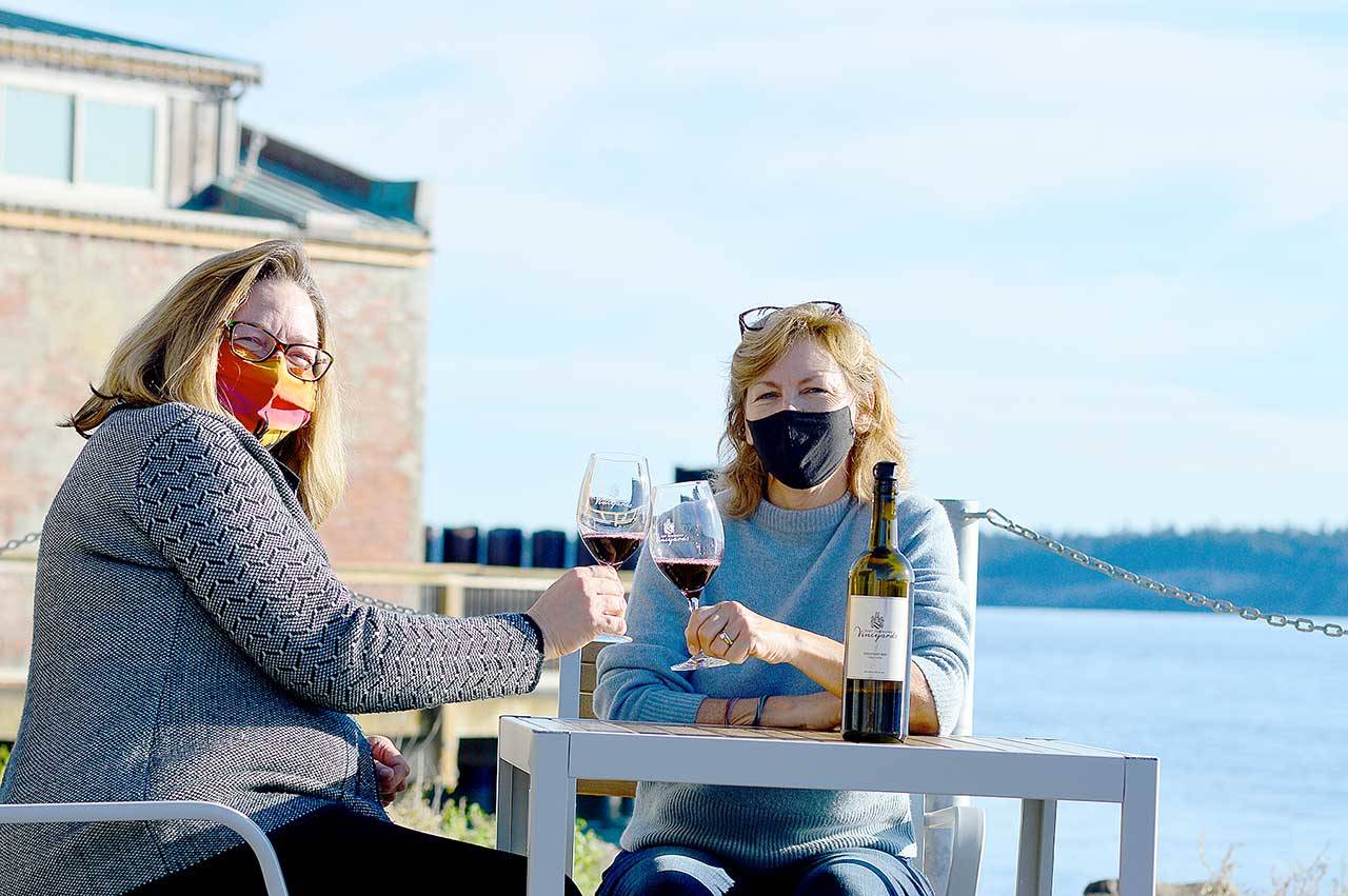 Tasting room lead Heidi Haney, left, and co-owner Karle Coppenrath await the day when the restored Port Townsend Vineyards Vintage Downtown building and plaza can host the gatherings it’s designed for. (Diane Urbani de la Paz/Peninsula Daily News)