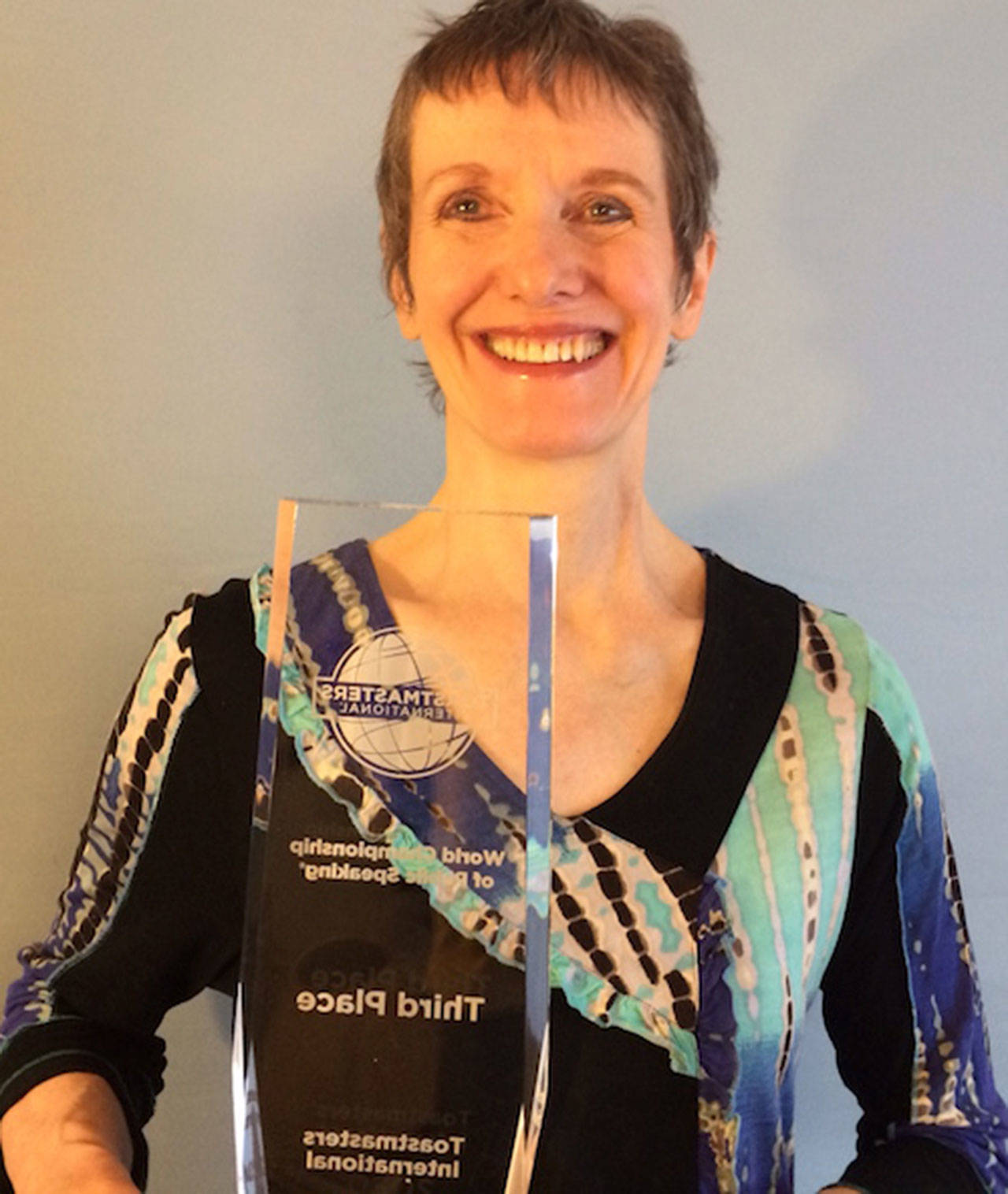 Lindy MacLaine, pictured here with her third place trophy from the 2020 Virtual World Championship of Public Speaking, invites the community to the next Skwim Toastmasters virtual meeting set for Tuesday.