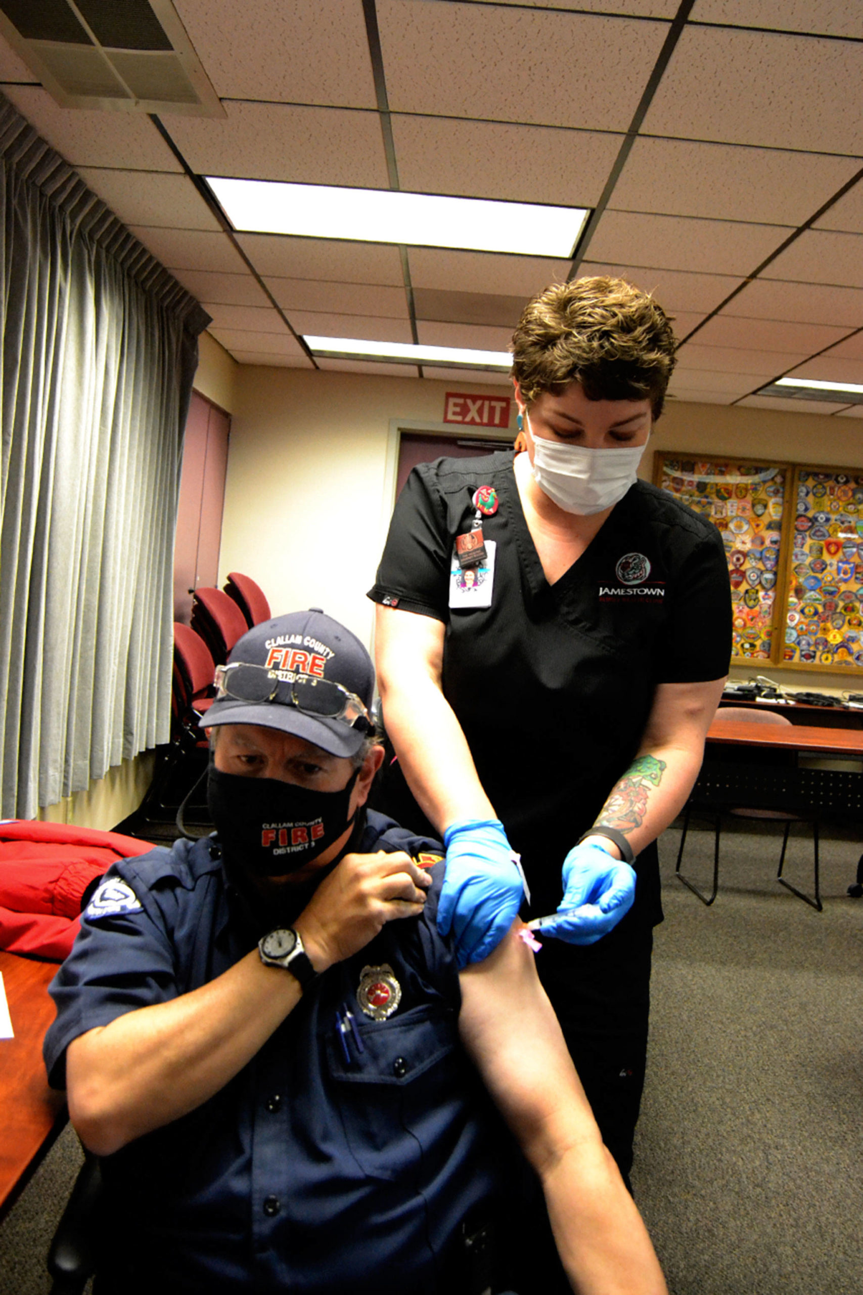 Blaine Zechenelly, a volunteer EMT and disaster planner with Clallam County Fire District 3, was the first Sequim-area first responder to receive a COVID-19 vaccine this week. Medical assistant Liz Moseley with Jamestown Family Health Clinic helped provide vaccinations Tuesday. (Matthew Nash/Olympic Peninsula News Group)