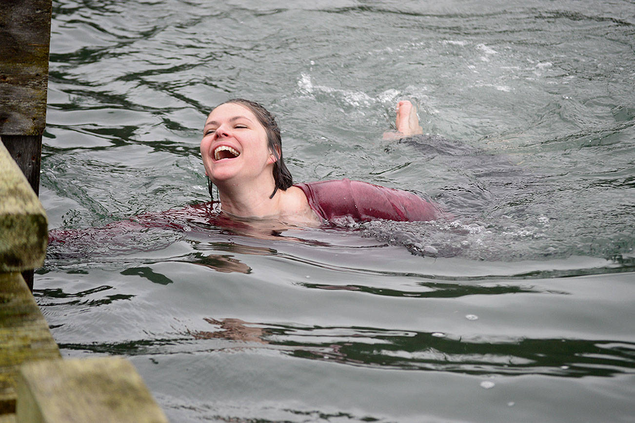 Graceful as a sea lioness, Laura Rogers of Port Hadlock took the plunge off the dock on New Year’s Day 2021. Diane Urbani de la Paz/Peninsula Daily News