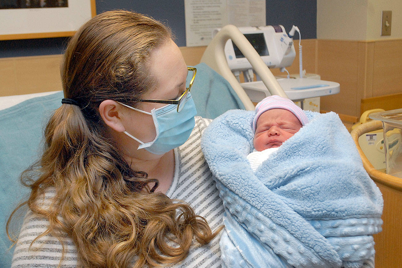 Kaitlyn Loghry of Forks looks at her son, Ethan Scott Loghry, at Olympic Medical Center. The baby is named for his father, Scott Loghry, and grandfather. (Keith Thorpe/Peninsula Daily News)