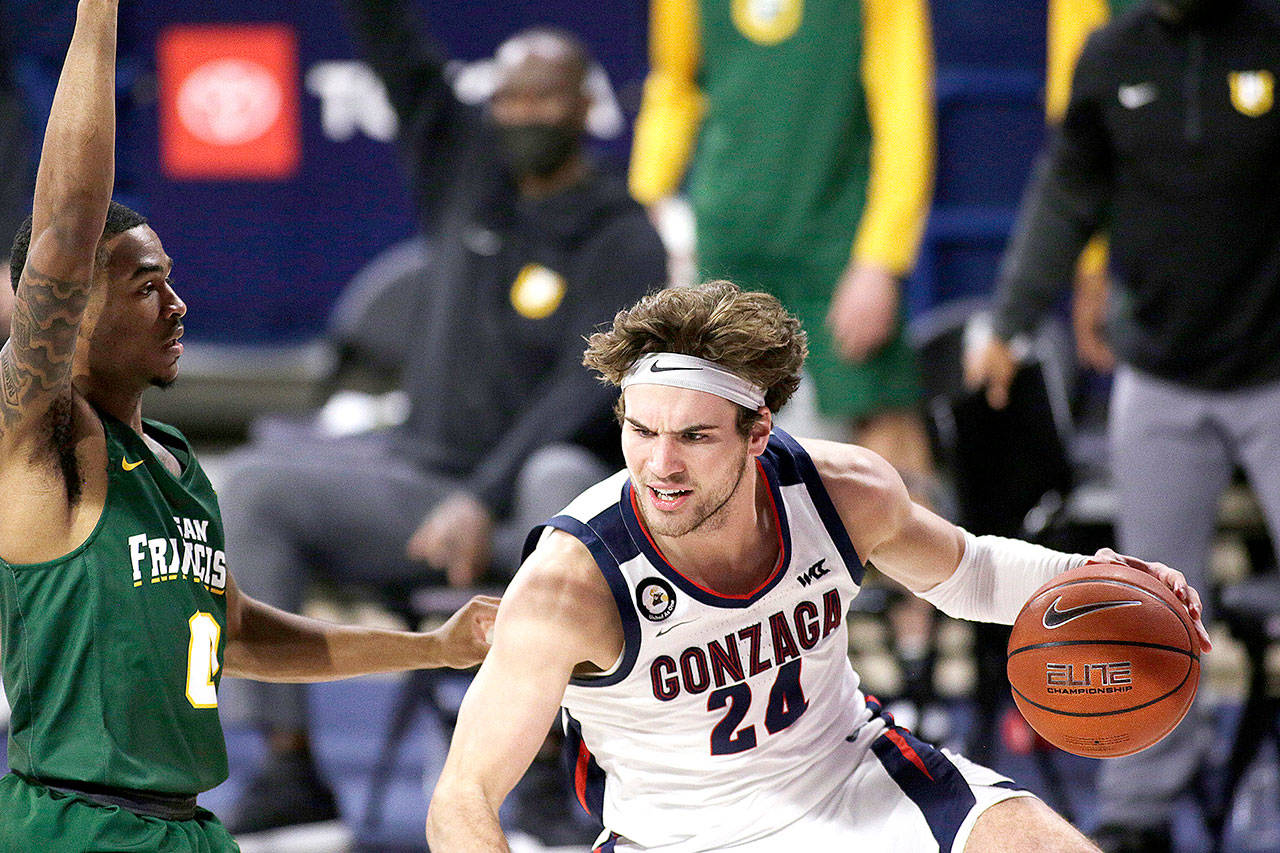 Gonzaga forward Corey Kispert, right, dribbles while pressured by San Francisco guard Khalil Shabazz during the first half in Spokane on Saturday. (Young Kwak/The Associated Press)