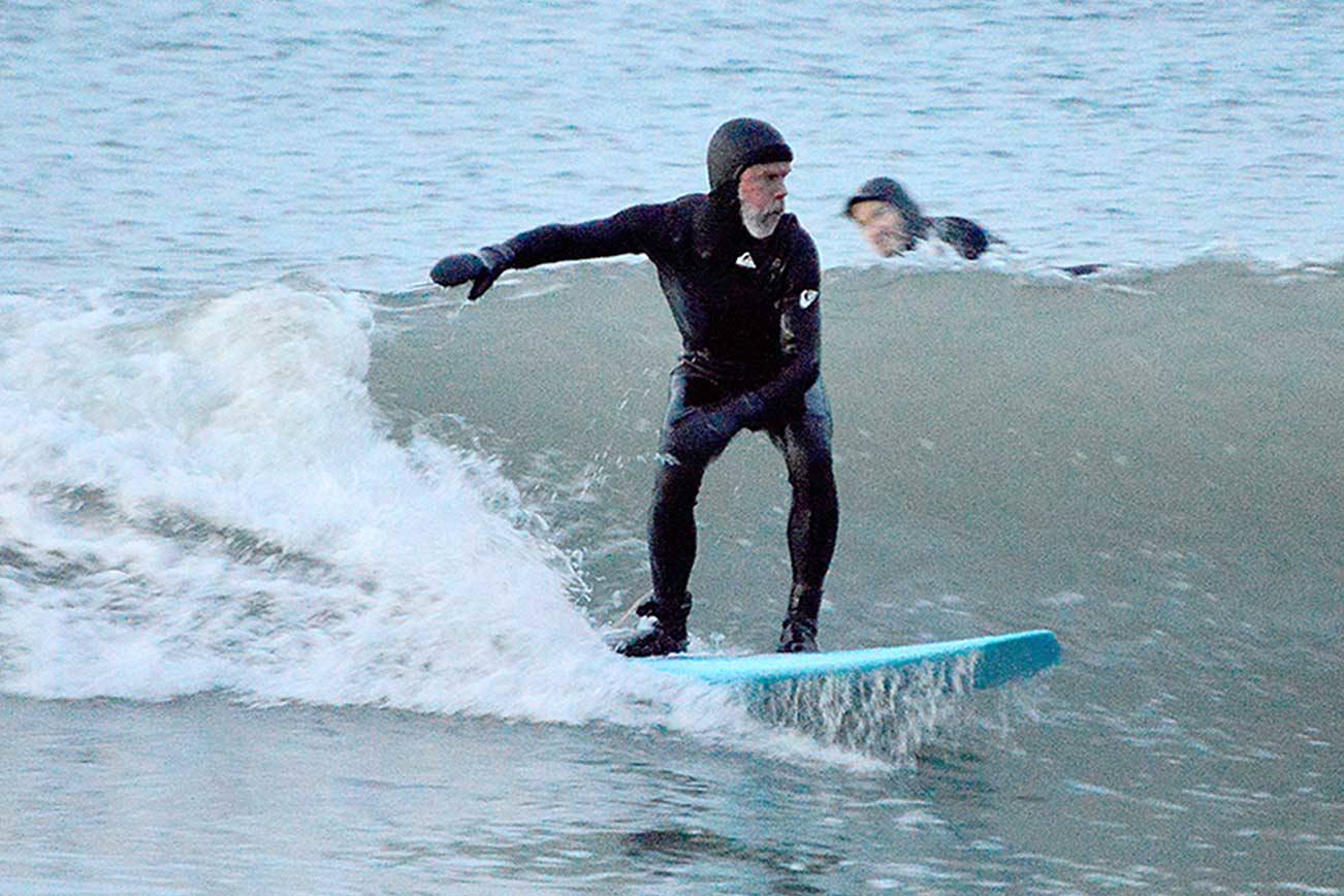 Piper Dunlap of Port Townsend rides the cold waves at North Beach County Park, where he and four other surfers stayed Sunday evening until it was too dark to see. (Diane Urbani de la Paz/Peninsula Daily News)