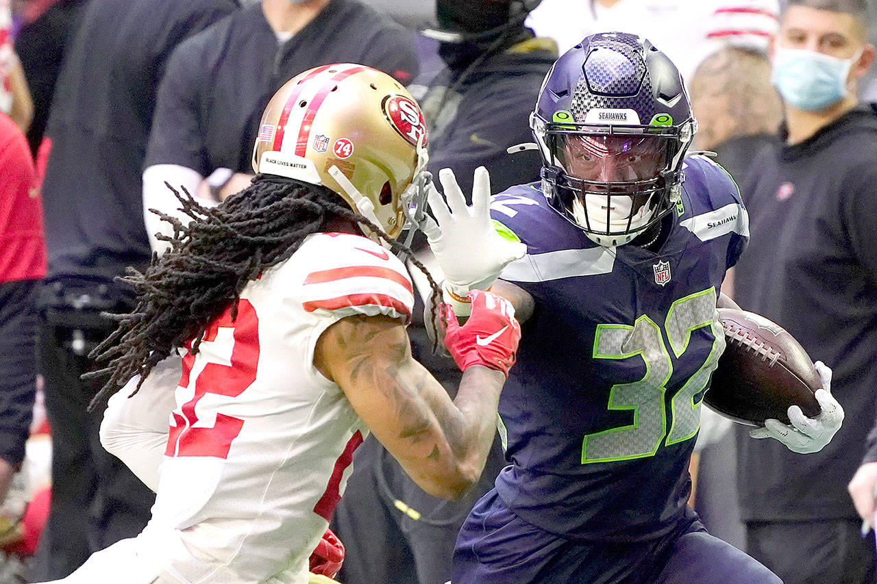 Seattle Seahawks running back Chris Carson (32) carries the ball Sunday against the San Francisco 49ers on Sunday in Glendale, Ariz. (Rick Scuteri/The Associated Press)