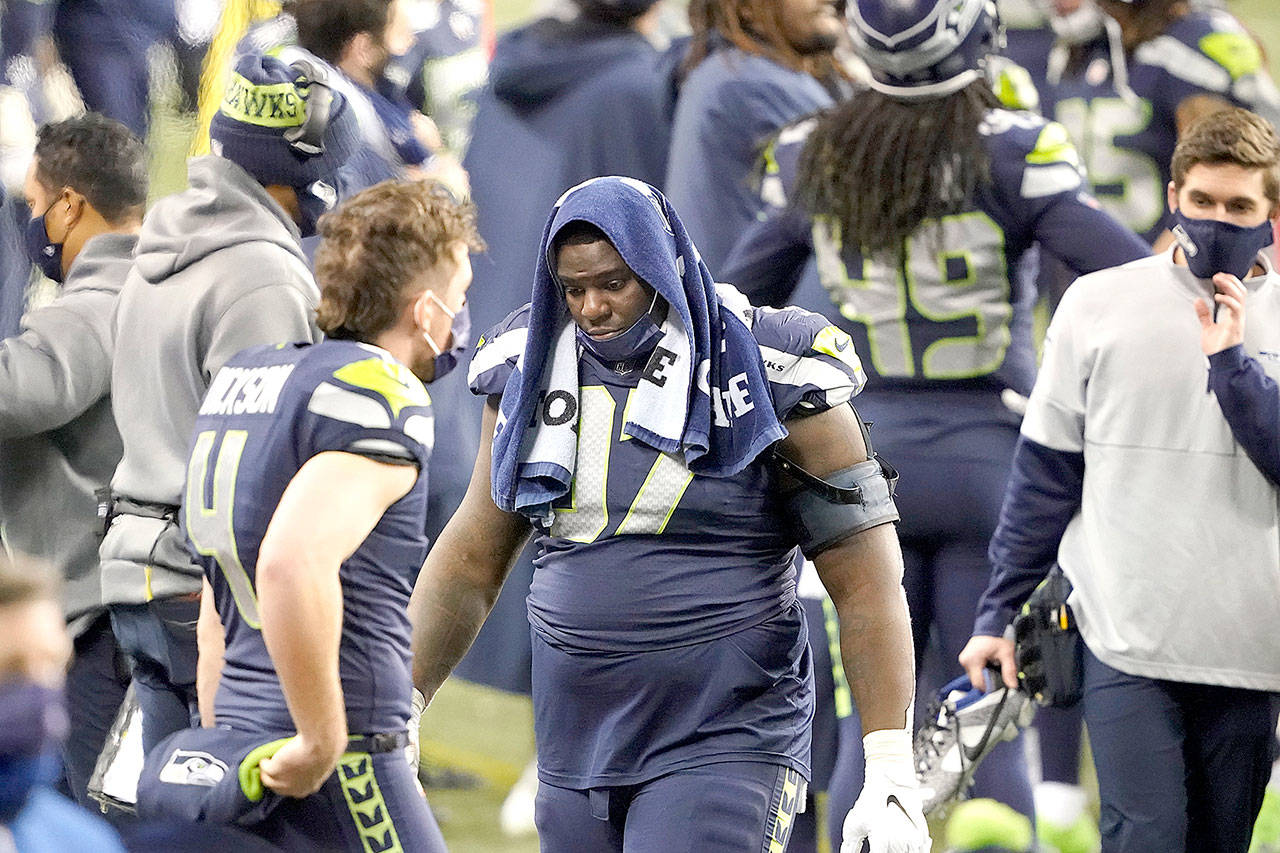 Seattle Seahawks defensive tackle Poona Ford turns away from the field as he stands at the bench late in the second half of an NFL wild-card playoff football game against the Los Angeles Rams, Saturday in Seattle. (Ted S. Warren/The Associated Press)