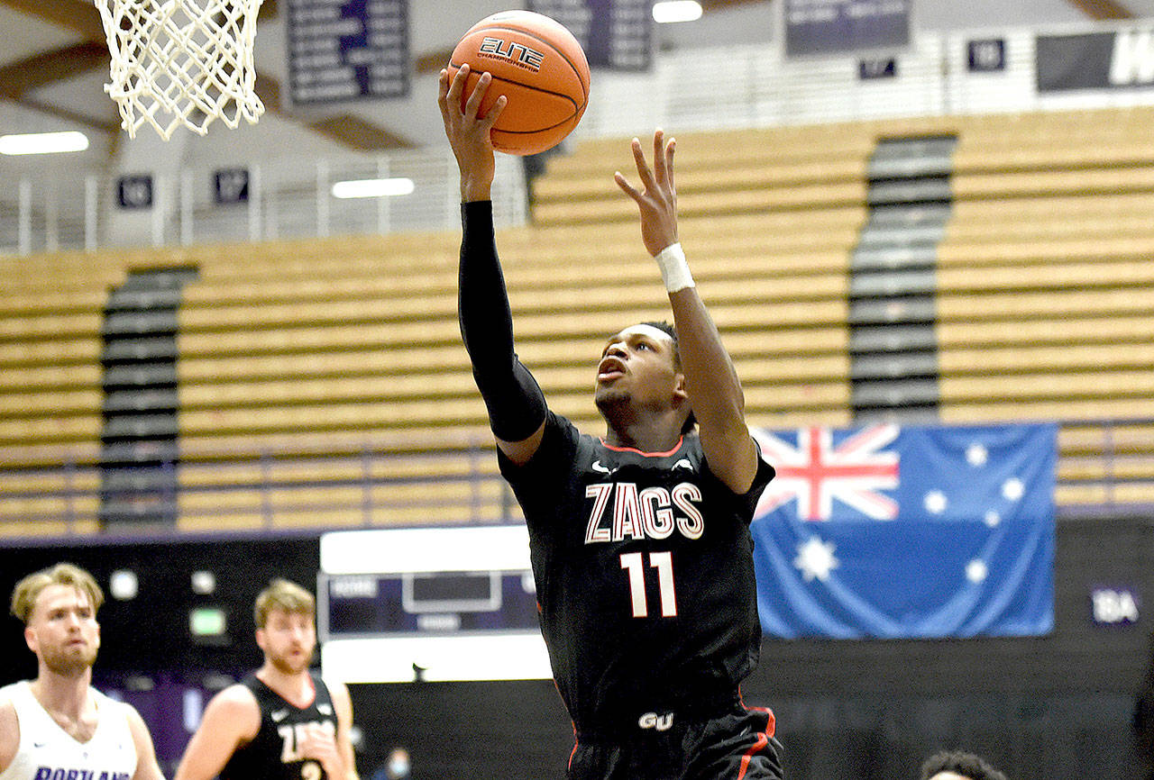 Gonzaga University guard Joel Ayayi, drives to the basket during the first half of an NCAA college basketball game against Portland in Portland, Ore., Saturday, Jan. 9, 2021. (AP Photo/Steve Dykes)