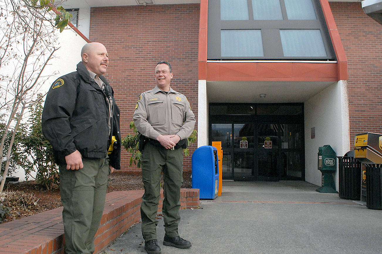 Keith Thorpe/Peninsula Daily News
Clallam County Sheriff's Deputy Ray Cooper, left, anbd Detective Sgt. Eric Munger keep watch at the front entrance of the Clallam County Courthoiuse in Port Angeles on Wednesday to guard against potential disturbances triggered by the election of President Joe Biden. In response to the Jan. 6 storming of the White House in Washington, D,C., and threats of violence in state capitals across the U.S., county officials opted to increase security at the courthouse on Inaugaration Day.