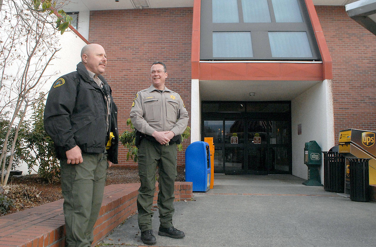 Clallam County Sheriff’s Deputy Ray Cooper, left, and Detective Sgt. Eric Munger keep watch at the front entrance of the Clallam County Courthouse in Port Angeles on Wednesday to guard against potential disturbances triggered by the election of President Joe Biden. In response to the Jan. 6 storming of the White House in Washington, D.C., and threats of violence in state capitals across the U.S., county officials opted to increase security at the courthouse on Inauguration Day. (Keith Thorpe/Peninsula Daily News)