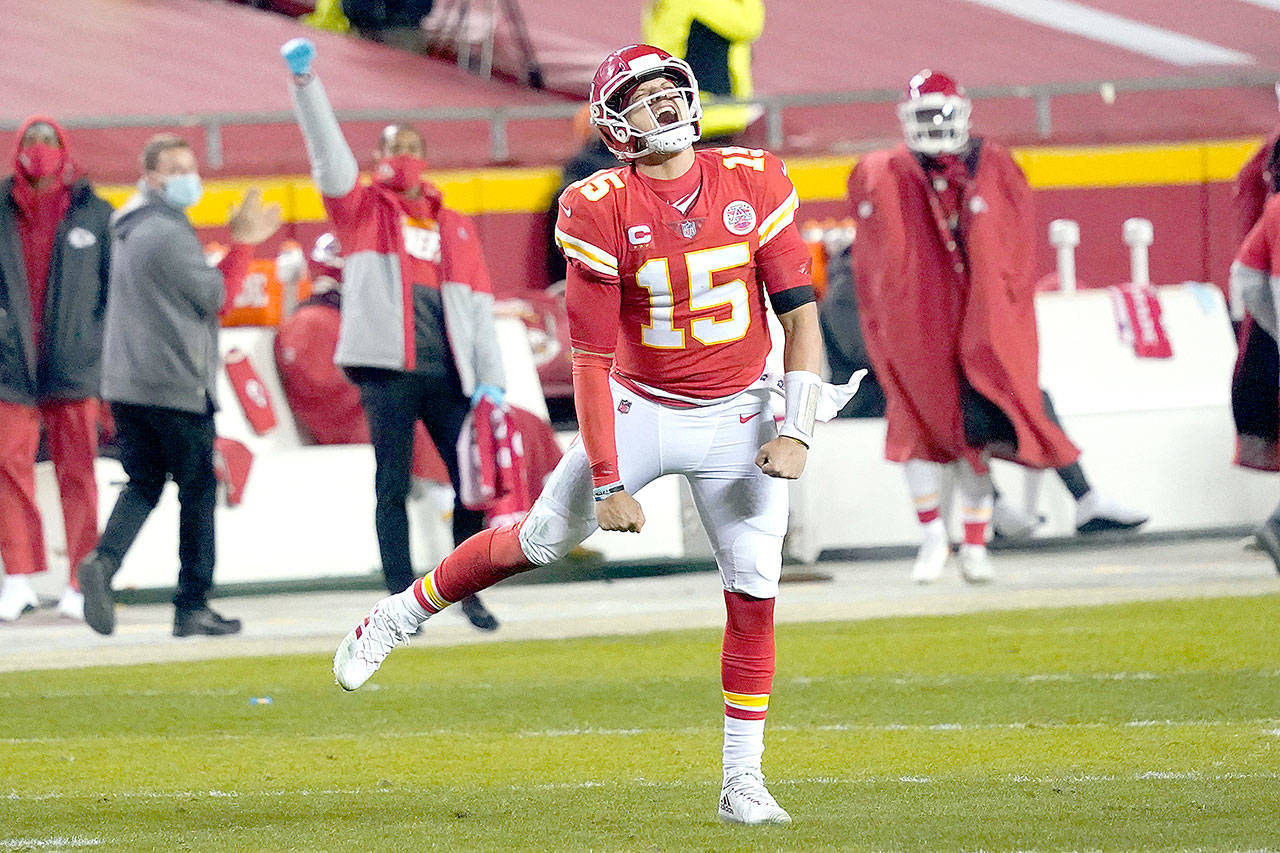 Kansas City Chiefs quarterback Patrick Mahomes celebrates after throwing a 5-yard touchdown pass to tight end Travis Kelce during the second half of the AFC championship NFL football game against the Buffalo Bills, Sunday, Jan. 24, 2021, in Kansas City, Mo. (AP Photo/Jeff Roberson)