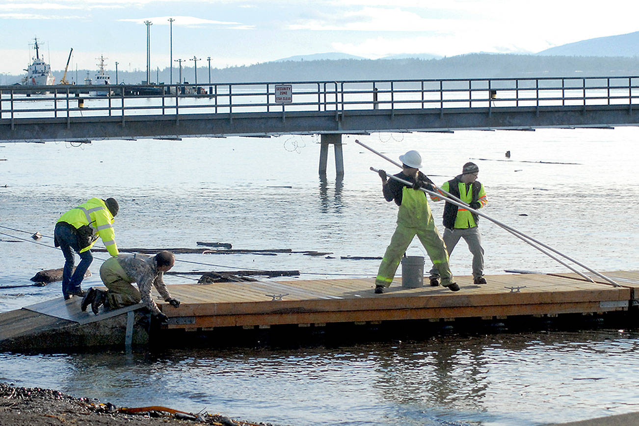 Keith Thorpe/Peninsula Daily News
Port Angeles Parks & Recreation Dept. workers, from left, Brooke Keohokaloke, Leon Leonard, Darryl Anderson and Elijah Hammel perform maintenance on a city boat dock on Ediz Hook on Tuesday. An approach ramp from the shore to the first float was damaged, necessitating the repair.