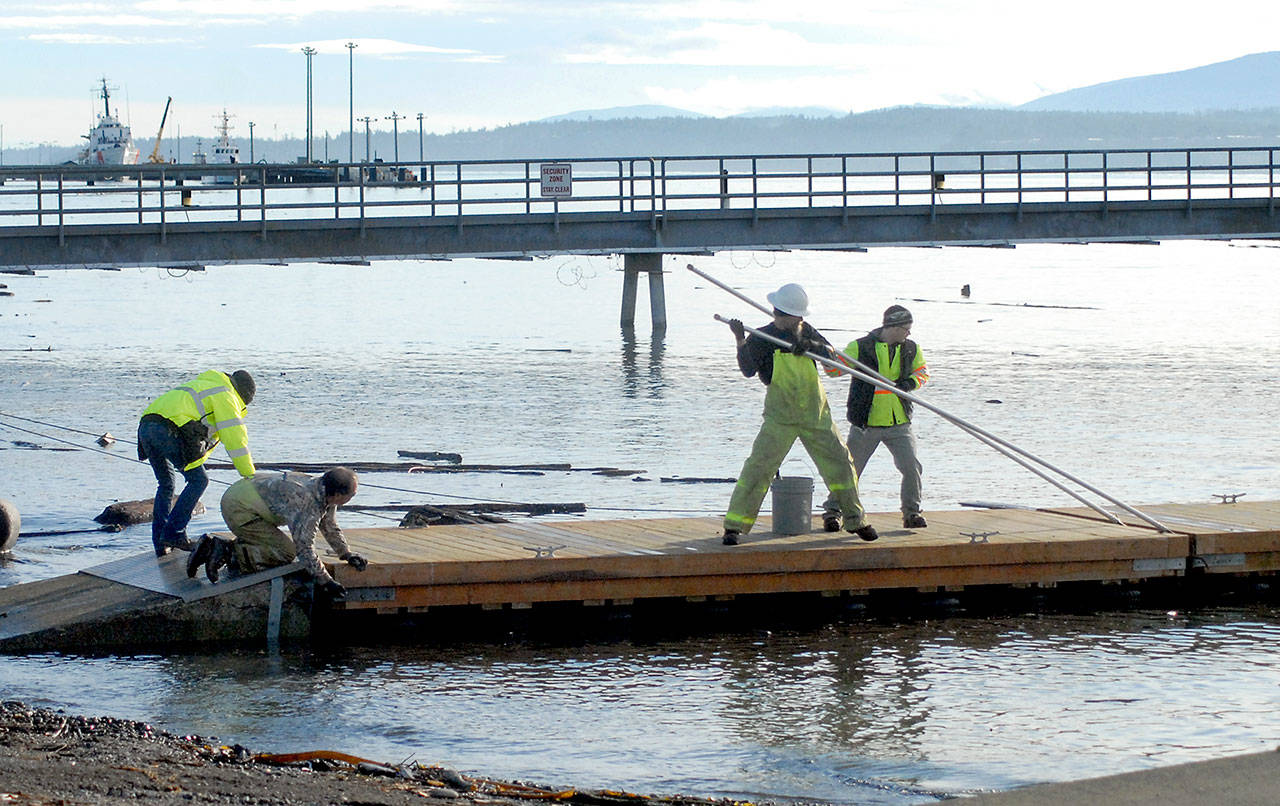 Keith Thorpe/Peninsula Daily News
Port Angeles Parks & Recreation Dept. workers, from left, Brooke Keohokaloke, Leon Leonard, Darryl Anderson and Elijah Hammel perform maintenance on a city boat dock on Ediz Hook on Tuesday. An approach ramp from the shore to the first float was damaged, necessitating the repair.