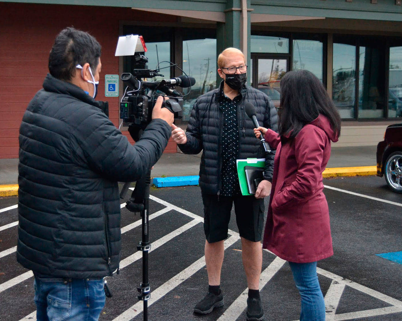 CNN photojournalist Taka Yokoyama and Kyung Lah, senior national correspondent, interview Sequim mayor William Armacost after a Coffee with the Mayor session Thursday morning in downtown Sequim. (Matthew Nash/Olympic Peninsula News Group)