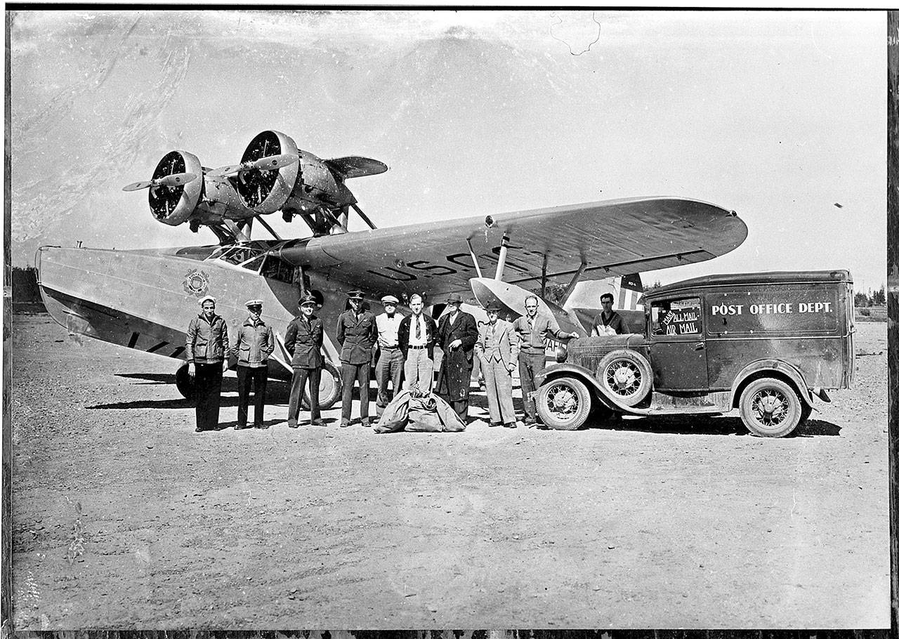 A USCG Douglas RD-4, post office truck and unidentified men gather at Cook’s Prairie, the location of the current William R. Fairchild International Airport in Port Angeles. (Courtesy of Bert Kellogg Collection/North Olympic Library System)