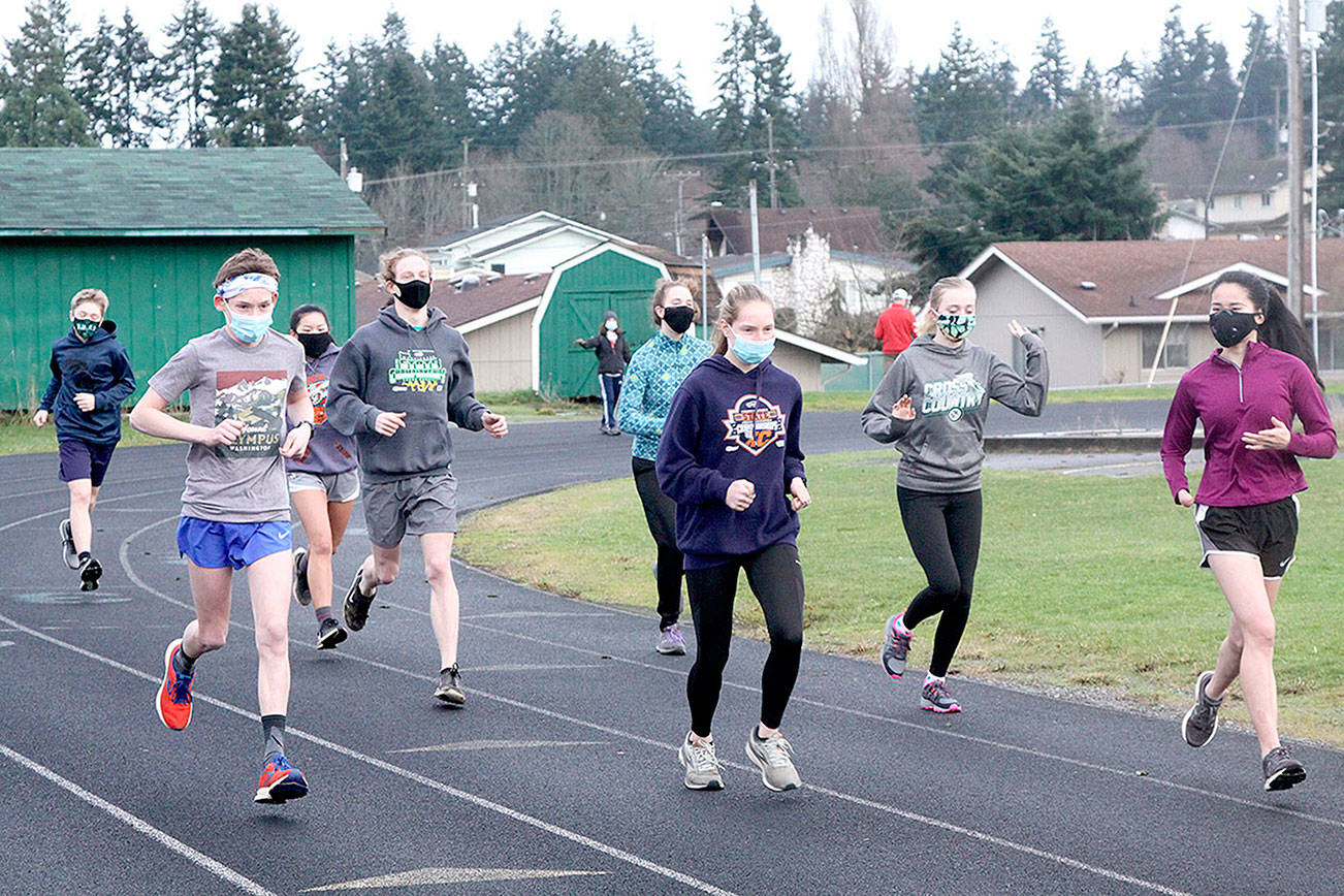 Dave Logan/for Peninsula Daily News
Port Angeles Roughrider cross country runners begin practicing Monday at the Port Angeles High School track. The first cross country meets are scheduled Saturday as prep sports slowly return to the Olympic Peninsula. Only cross country can begin competing at the moment but other sports are practicing in hopes of beginning in mid-February.