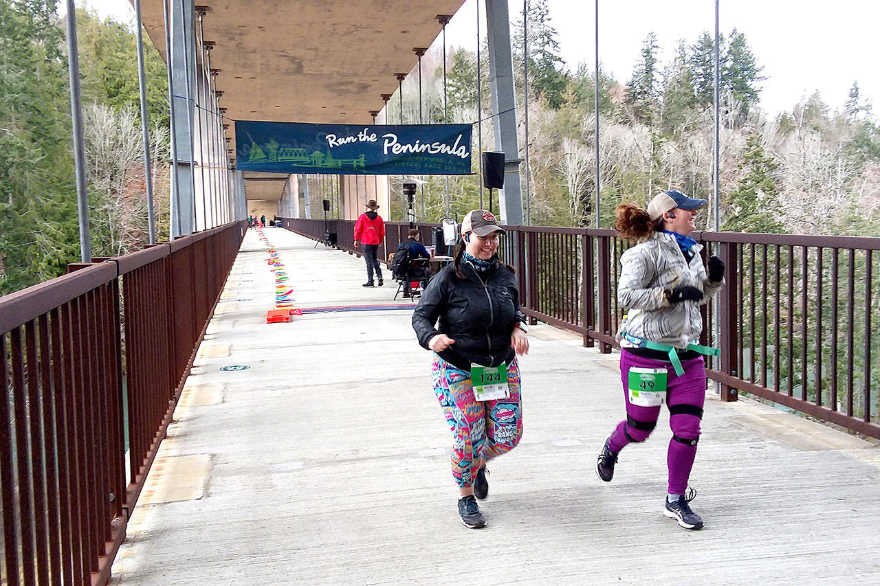 Pierre LaBossiere/Peninsula Daily News Brady Simis of Renton, left and Angela Smith of Buckley get started on their 10K runs at the Elwha Bridge Run Saturday morning.