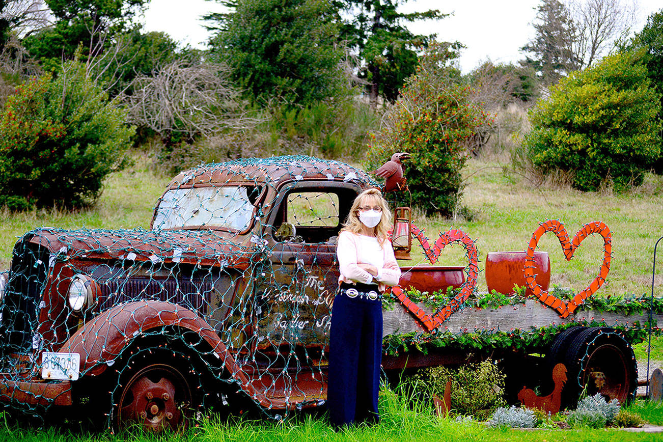 Barber Debbie Hinton of Port Townsend's Victorian Clipper barbershop had a vintage truck towed in from Chimacum decades ago, with the intention of planting a garden in it. These days it's a changing holiday display festooned in February with Valentine's Day decor. (Diane Urbani de la Paz/Peninsula Daily News)
