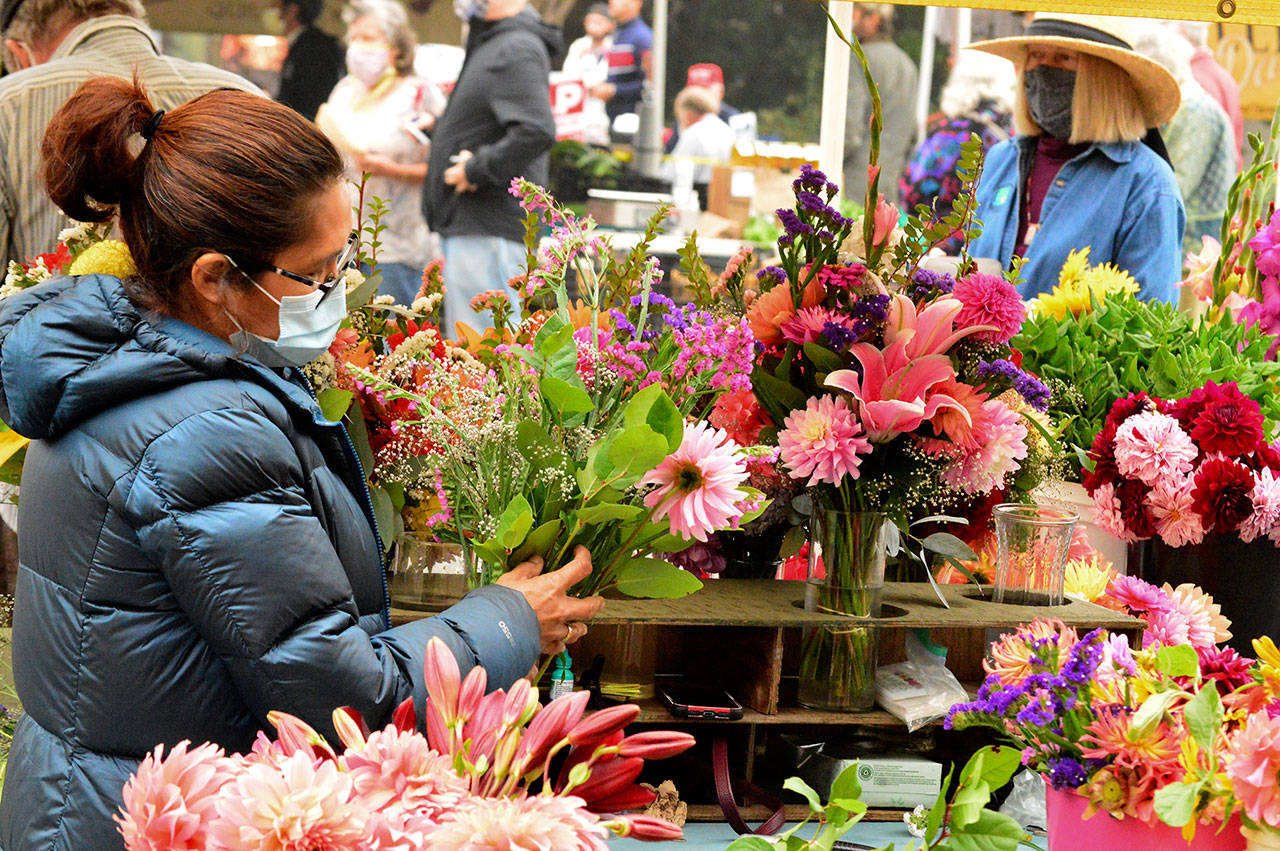 Amie Albaugh of Sequim, seen at the market stand last year, is among the vendors at the Jefferson County Farmers Market. The market invites farmers, chefs and artisans of color to apply for grants from its new startup fund. (Diane Urbani de la Paz/Peninsula Daily News)