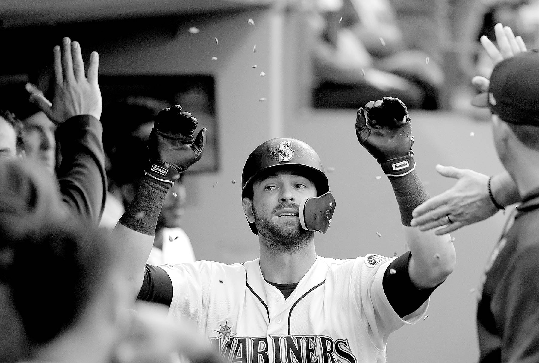 FILE - Seattle Mariners' Mitch Haniger is congratulated and showered with sunflower seeds after his solo home run against the Houston Astros in the third inning of a baseball game in Seattle, in this Tuesday, June 4, 2019, file photo. Mitch Haniger never saw the field in 2020 for the Seattle Mariners. He barely saw the field in 2019. He's nearly three years removed from being an All-Star, but the Mariners believe that with Haniger now full healthy he can once again be that caliber of player. (AP Photo/Elaine Thompson, File)