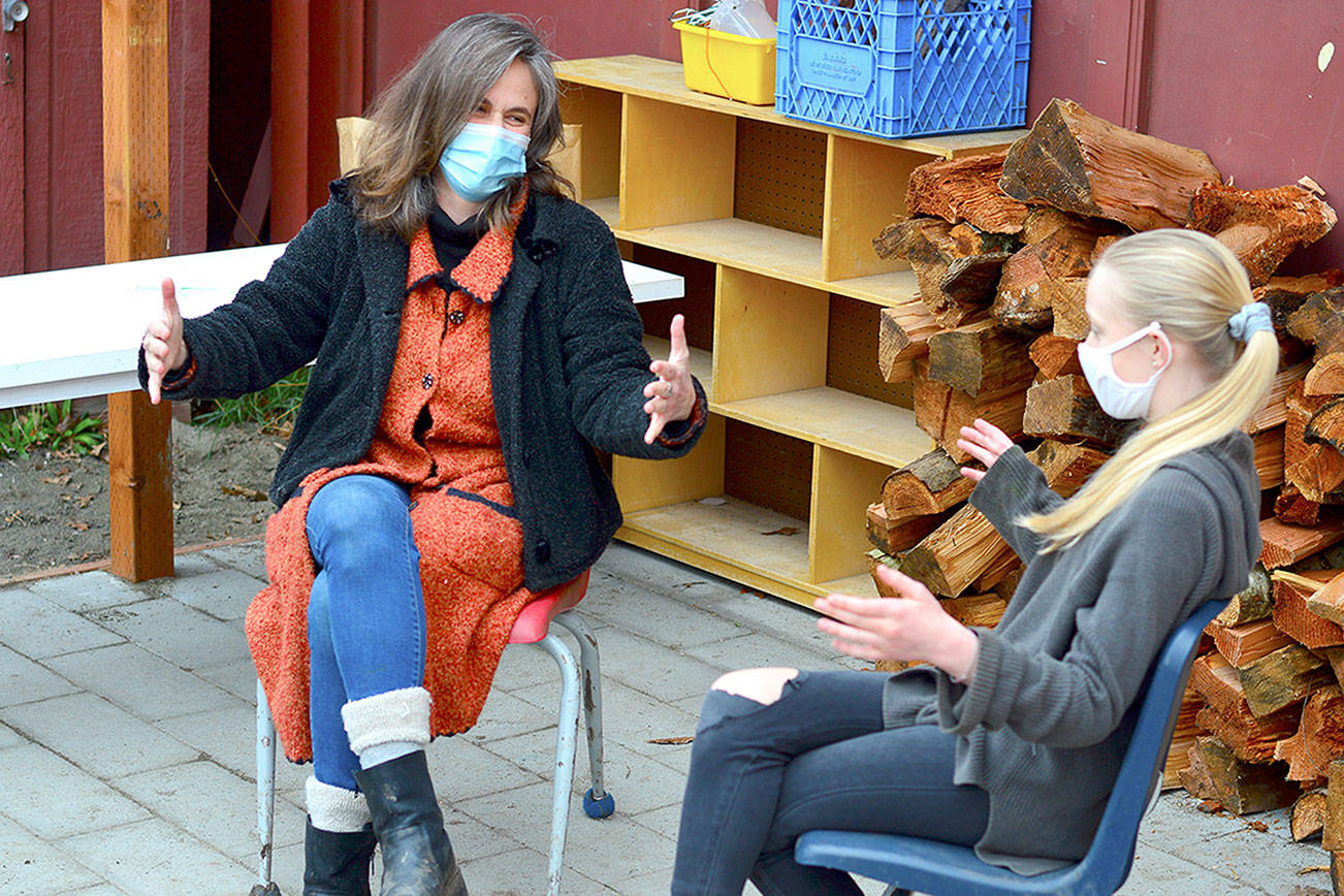 Benji Project teacher Heather McRae-Woolf talks with her daughter Orlanda on the Swan School patio, the setting for a new mindfulness circle for teens in Port Townsend. (Diane Urbani de la Paz/Peninsula Daily News)