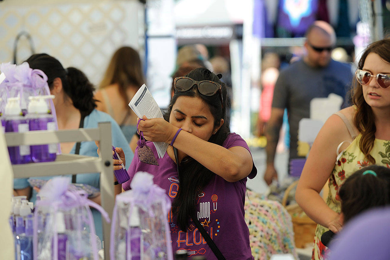 Rashi Jain of Seattle smells some lavender products in the Let's Do Lavender booth at the Lavender Festival Street Fair in July 2019. This summer will be the second consecutive time the novel coronavirus pandemic has led organizers to cancel the Street Fair in Carrie Blake Community Park. Matthew Nash/Olympic Peninsula News Group