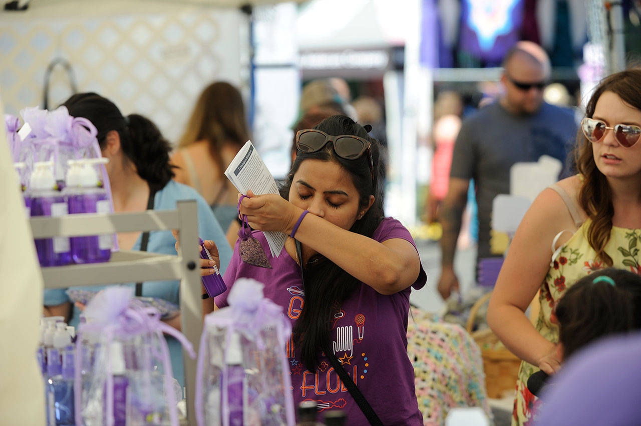 Rashi Jain of Seattle samples lavender products in the Let’s Do Lavender booth at the Lavender Festival Street Fair in July 2019. This summer will be the second consecutive time the novel coronavirus pandemic has led organizers to cancel the Street Fair in Carrie Blake Community Park. (Matthew Nash/Olympic Peninsula News Group)