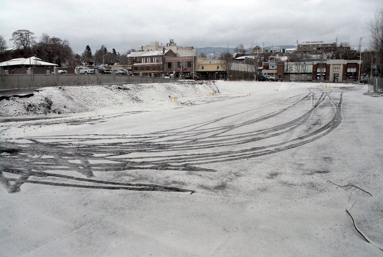 Tire tracks in the snow are present at the site of a future luxury hotel planned by the Lower Elwha Klallam Tribe in downtown Port Angeles. (Keith Thorpe/Peninsula Daily News)